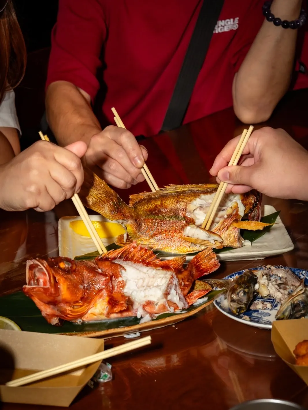 Guests sharing grilled kinki